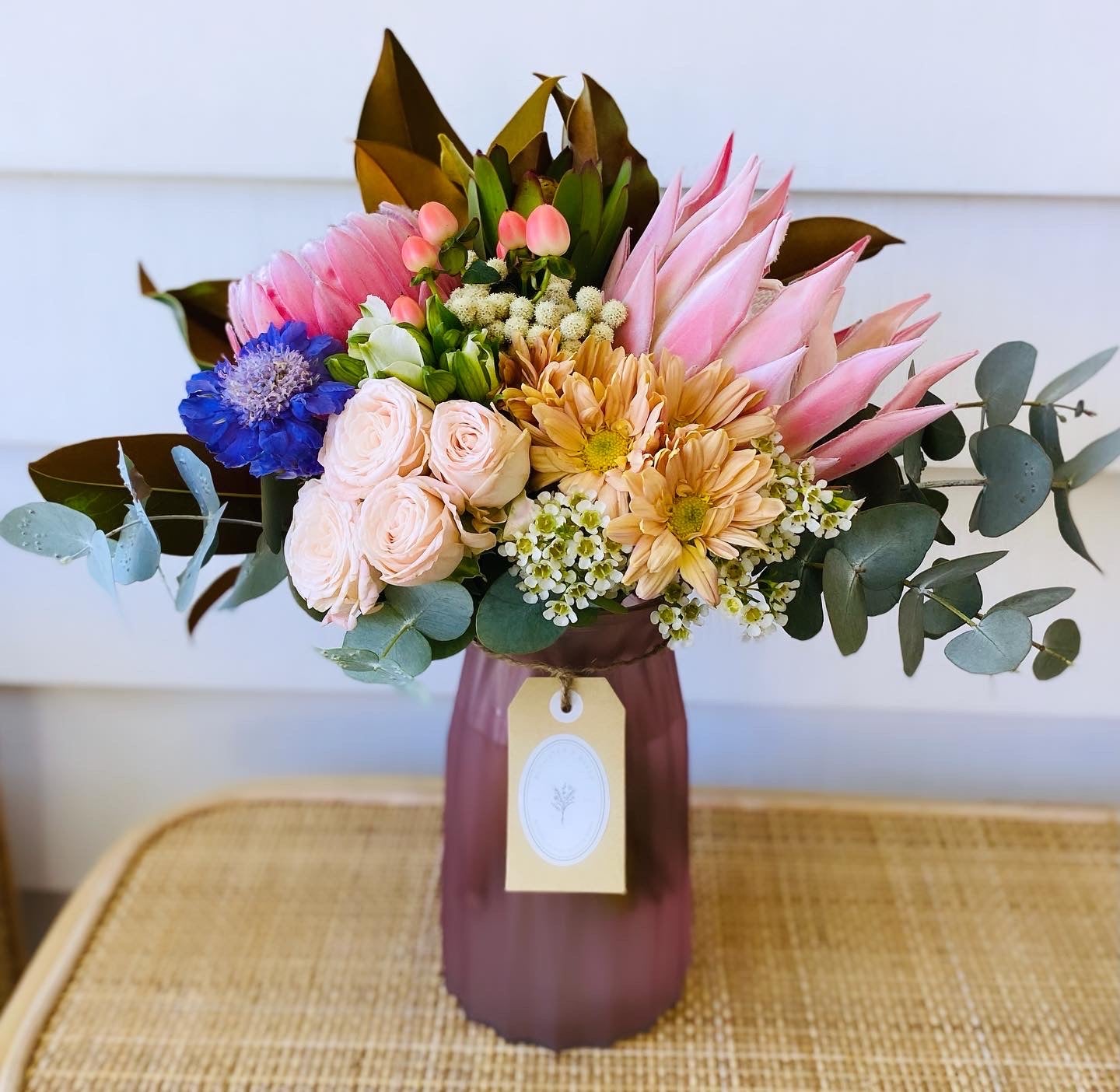 Mixed posy in glass vase in