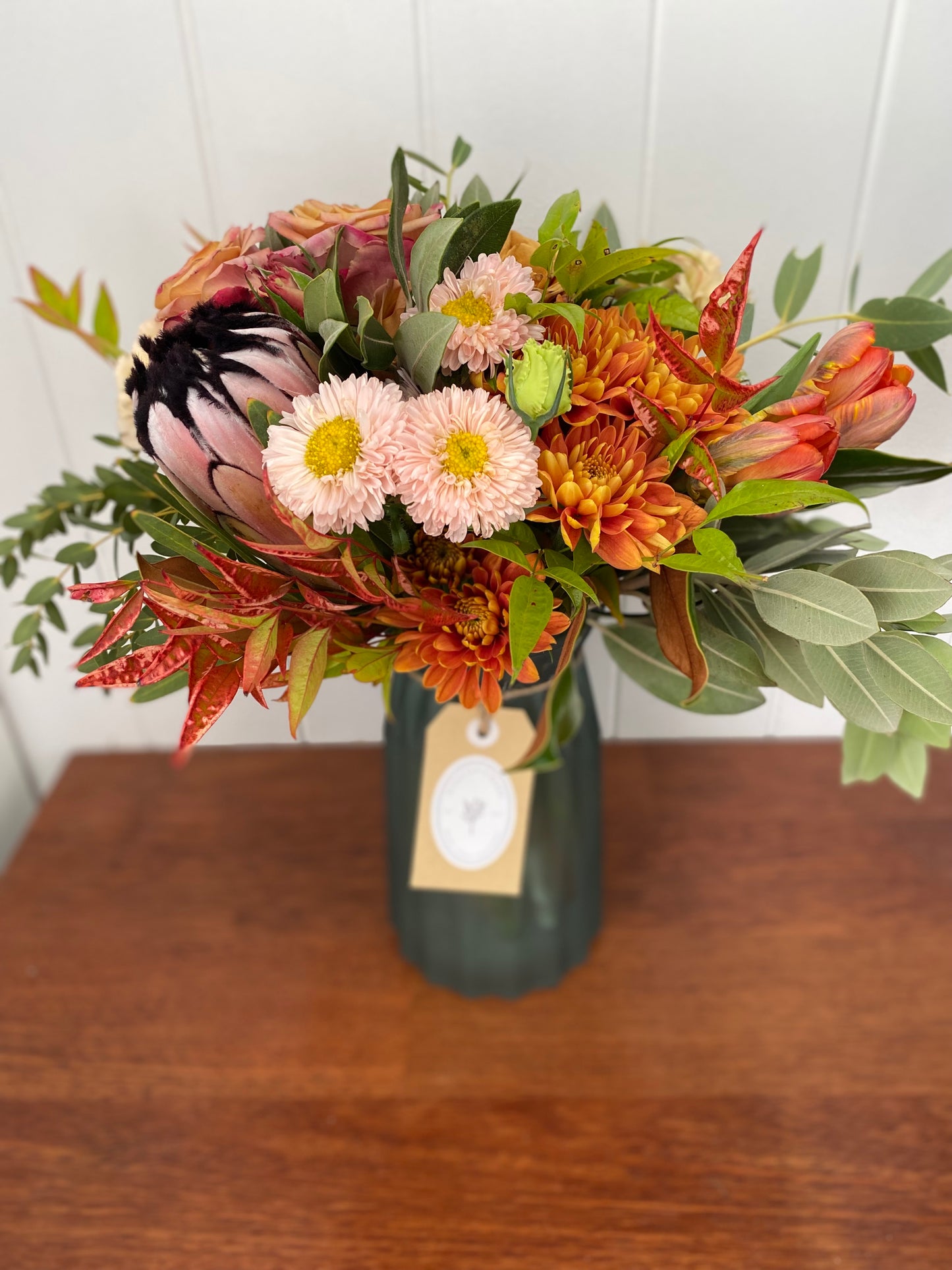 Mixed posy in glass vase in