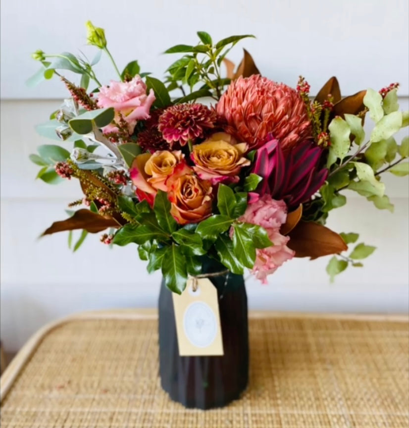Mixed posy in glass vase in