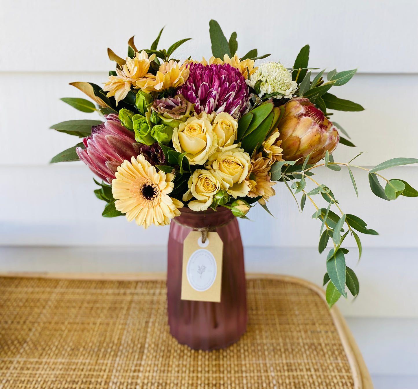 Mixed posy in glass vase in