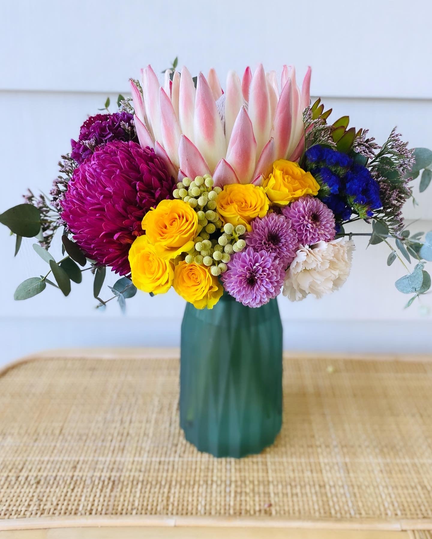 Mixed posy in glass vase in