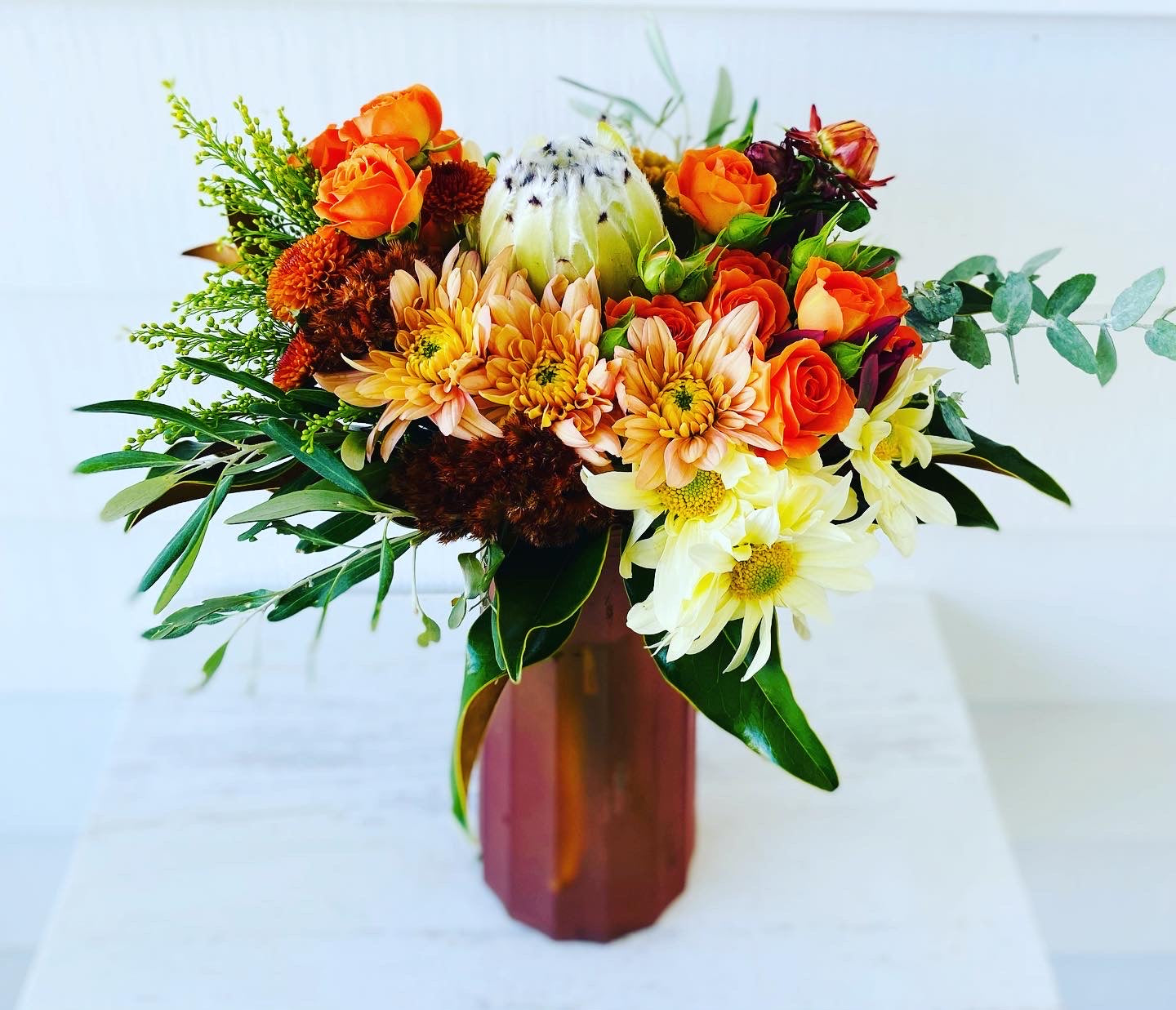 Mixed posy in glass vase in