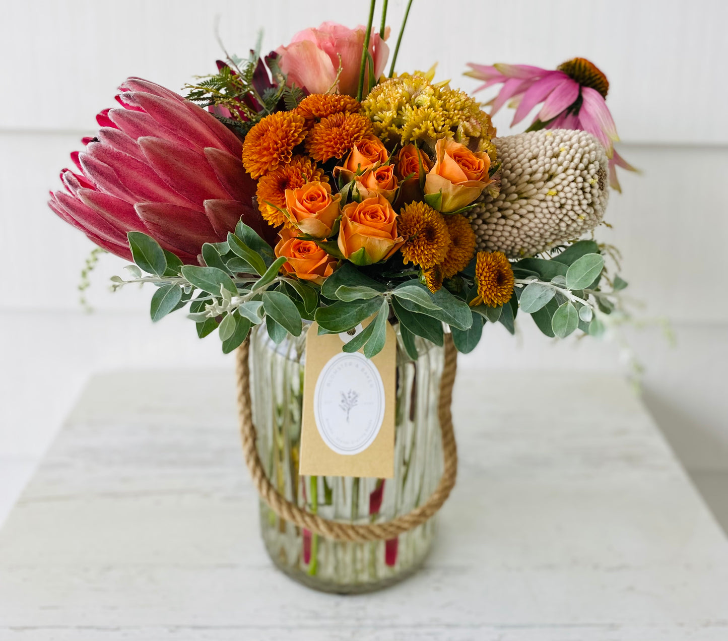 Mixed posy in glass vase in