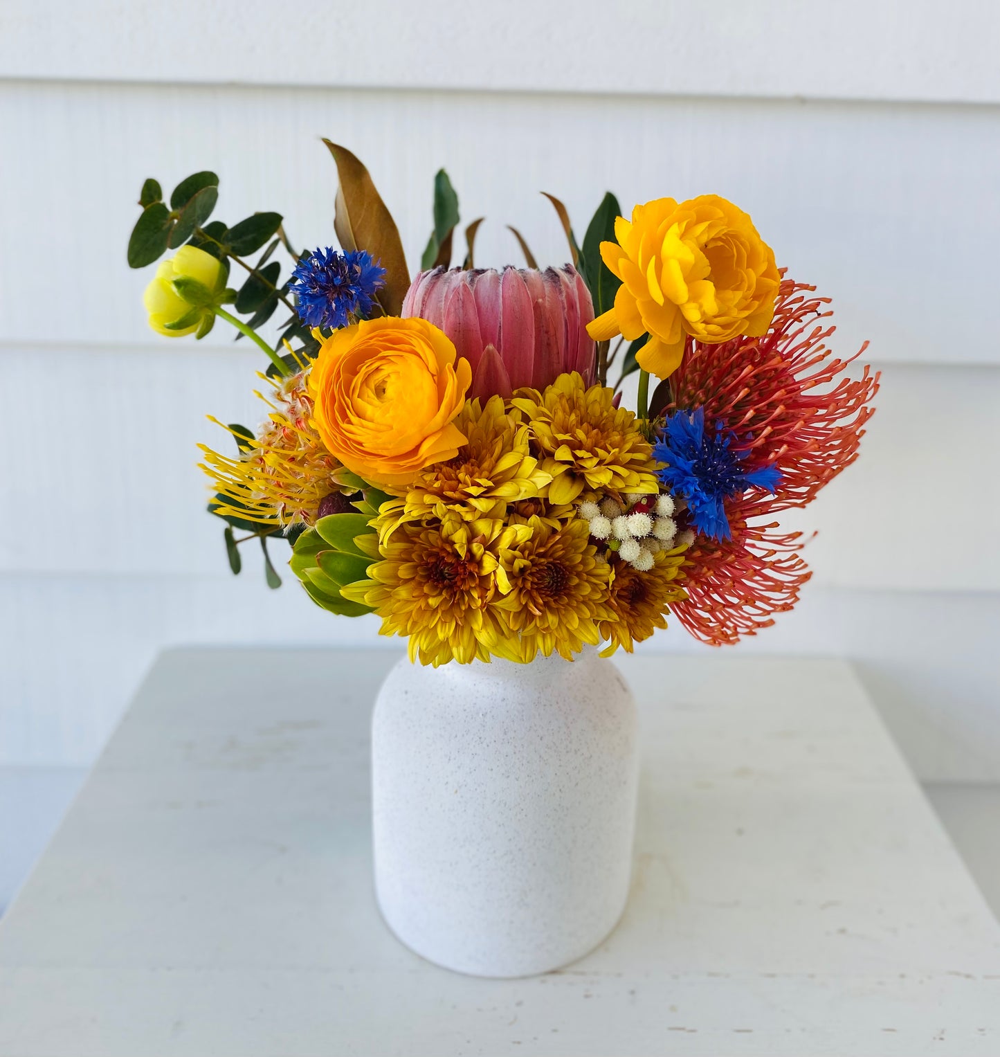 Mixed posy in glass vase in