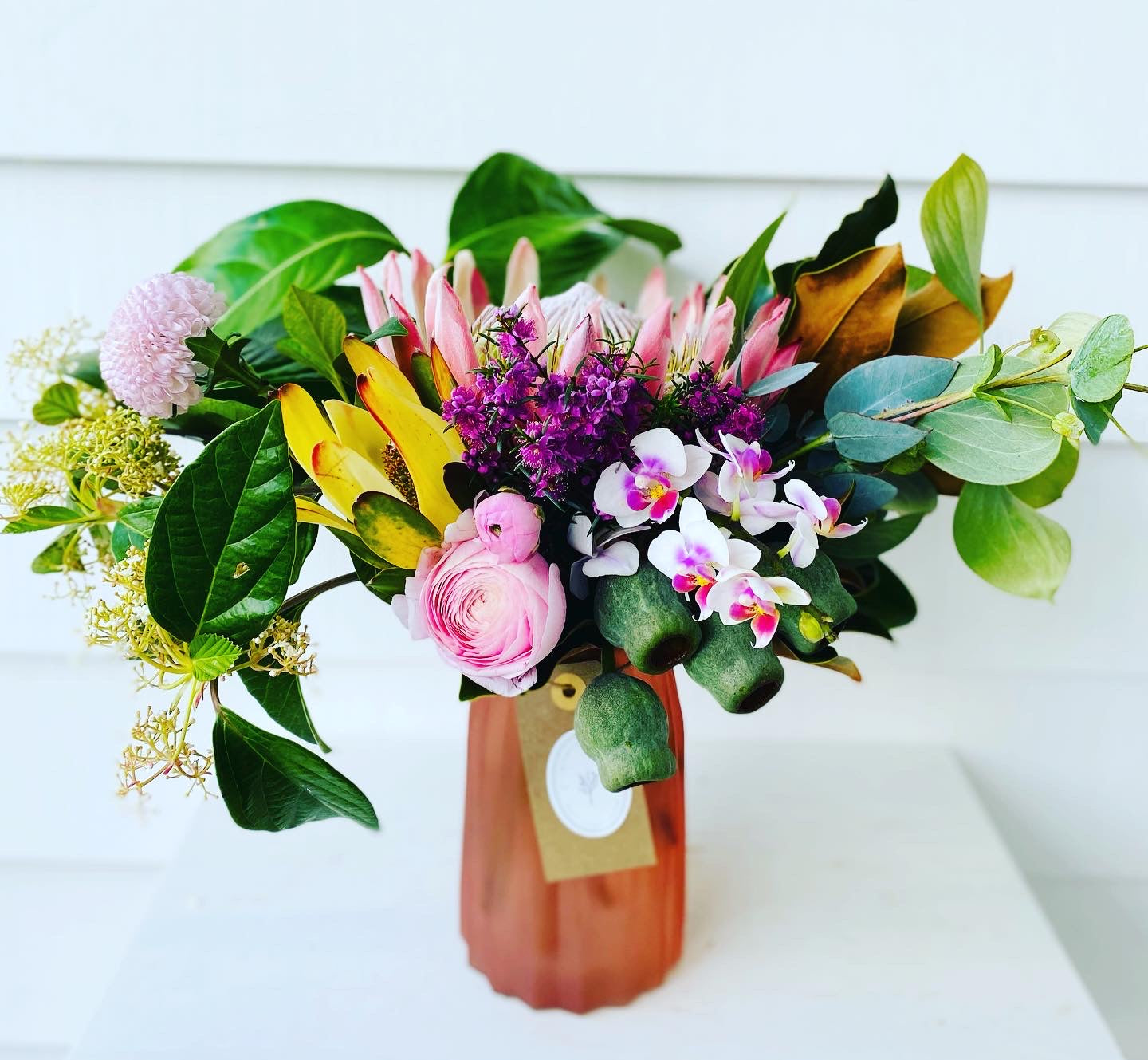 Mixed posy in glass vase in