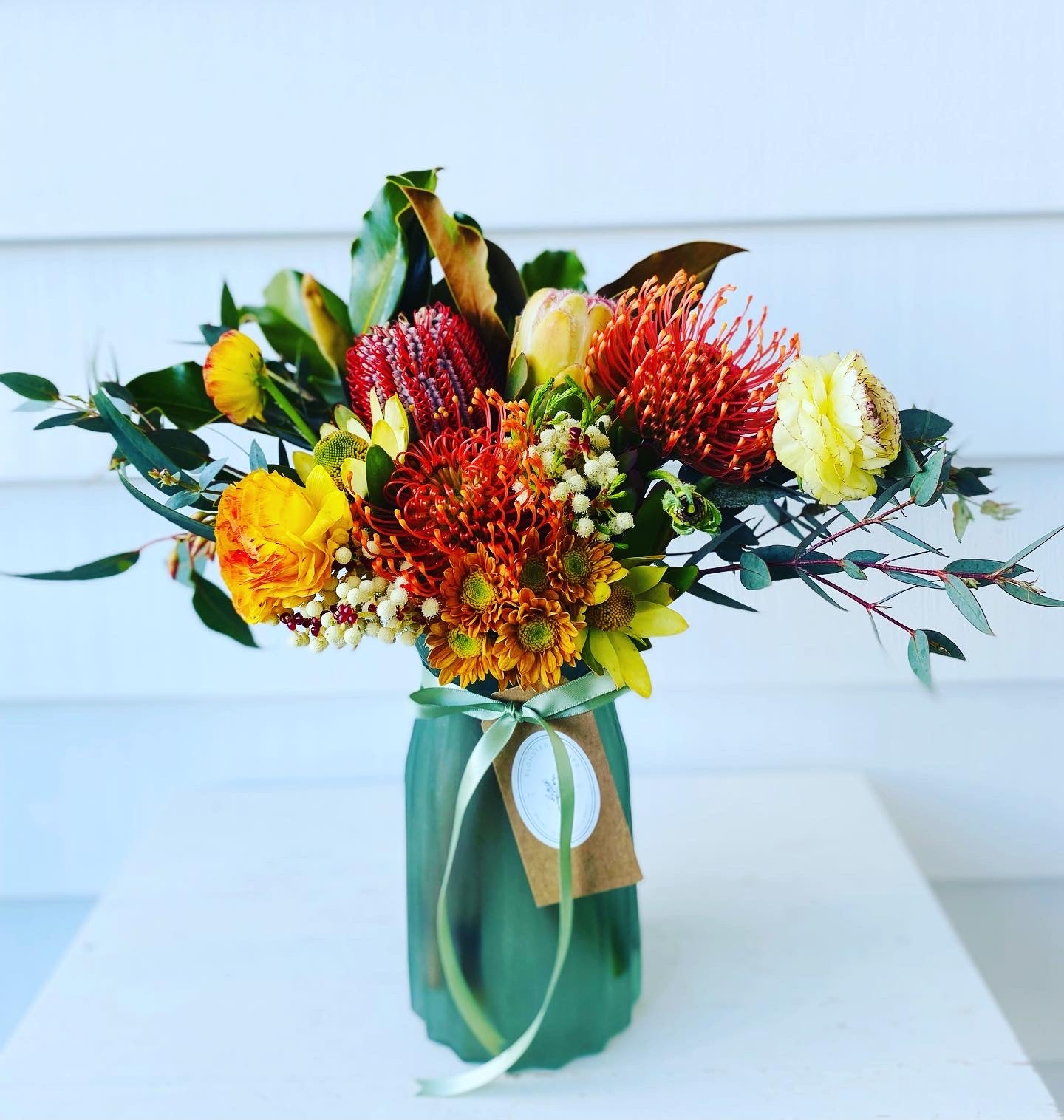 Mixed posy in glass vase in