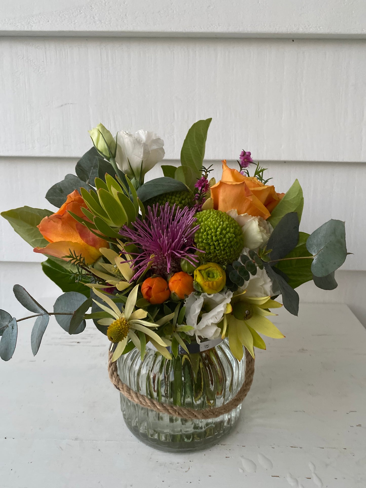 Mixed posy in glass vase in