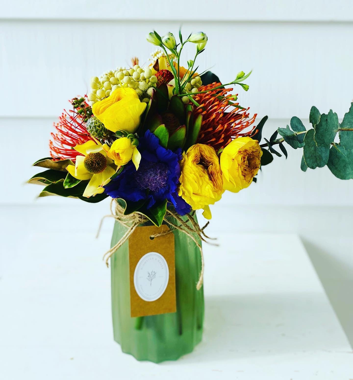 Mixed posy in glass vase in