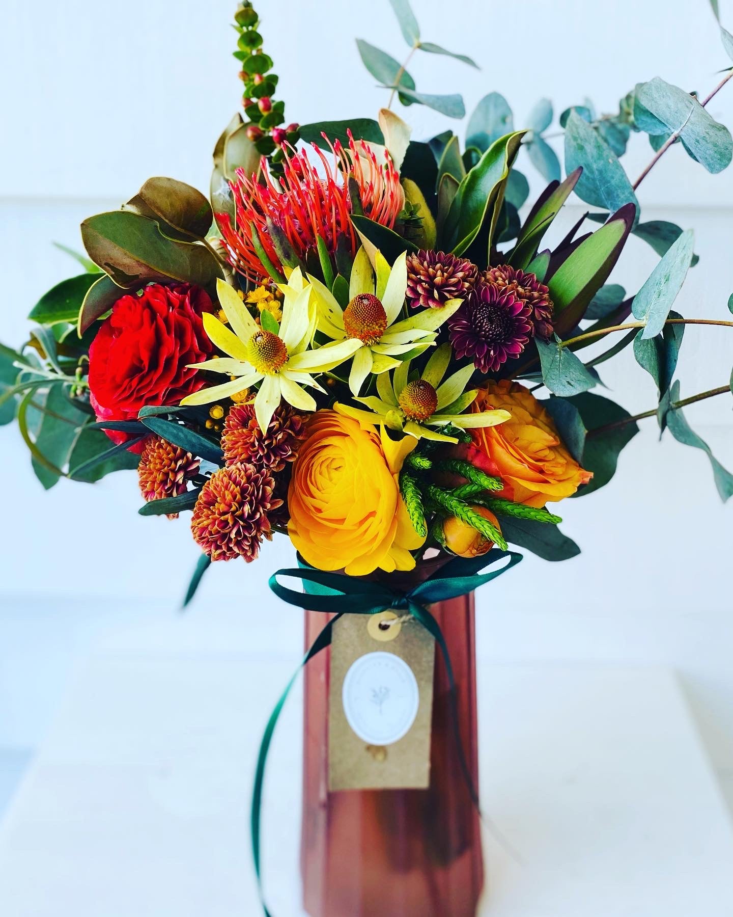 Mixed posy in glass vase in