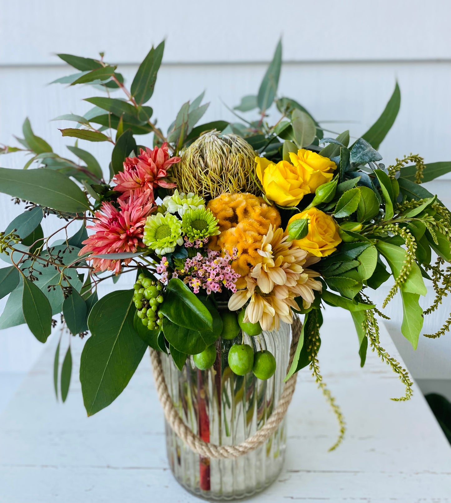Mixed posy in glass vase in
