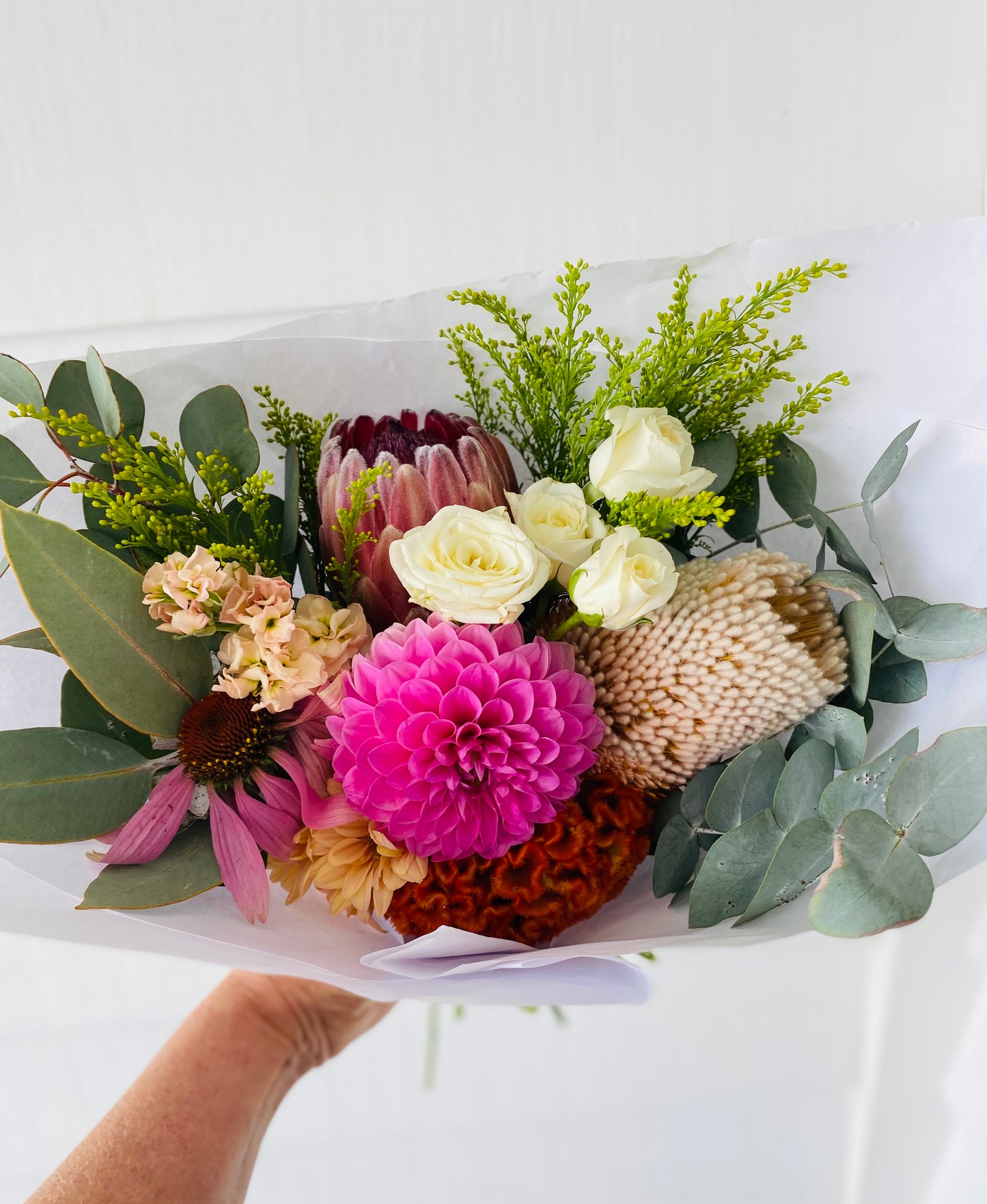A mixed posy with a small Robert Gordon shopping bag