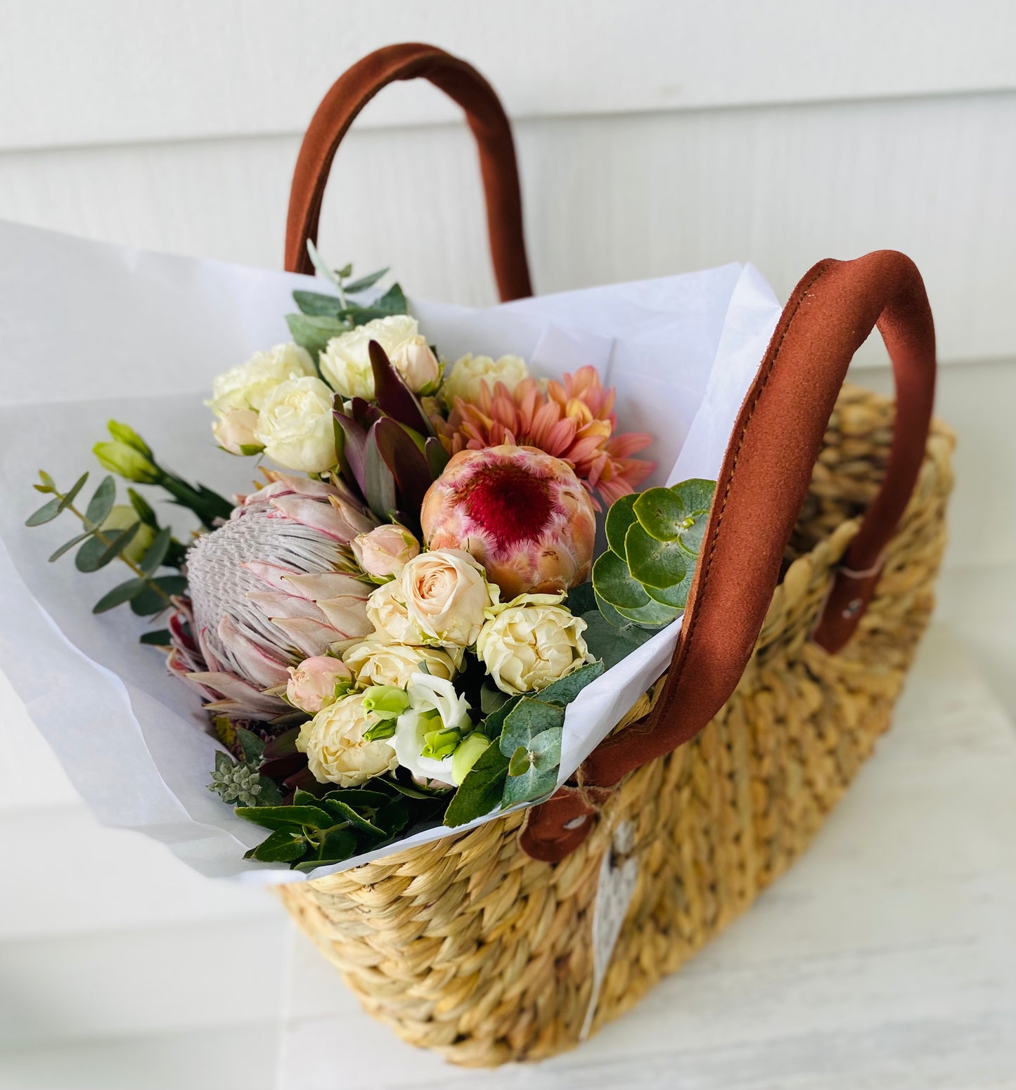 A mixed posy with a small Robert Gordon shopping bag