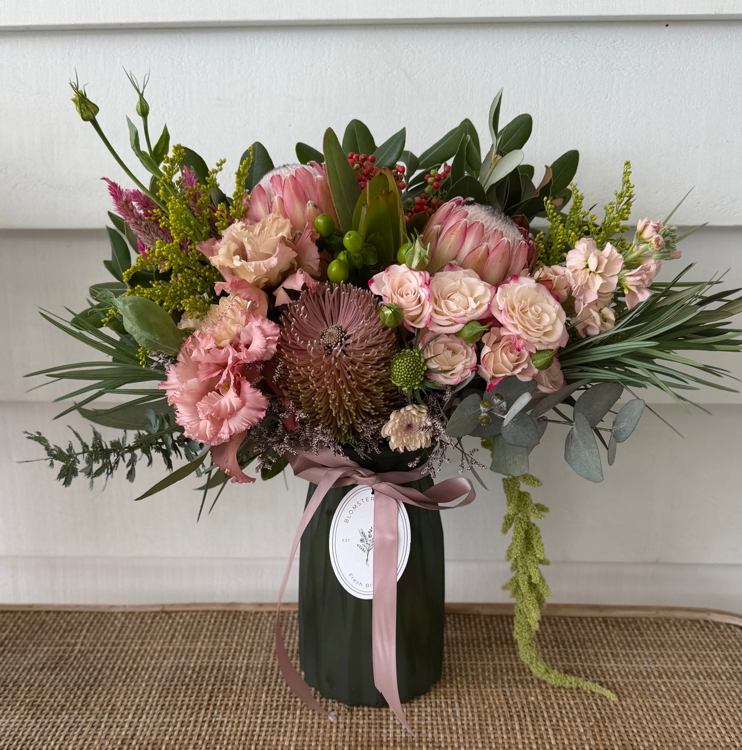 Mixed posy in glass vase in
