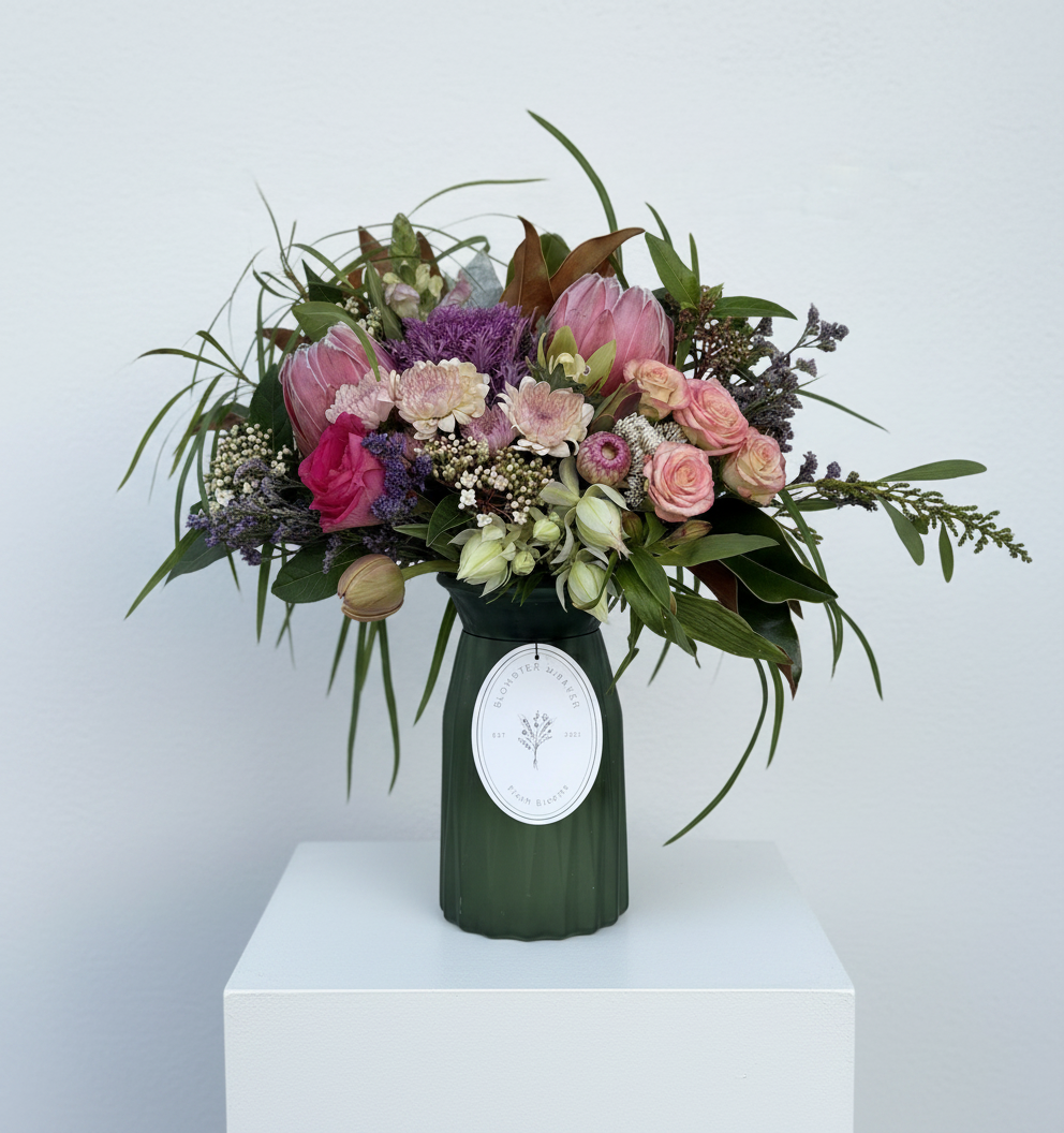 Mixed posy in glass vase in