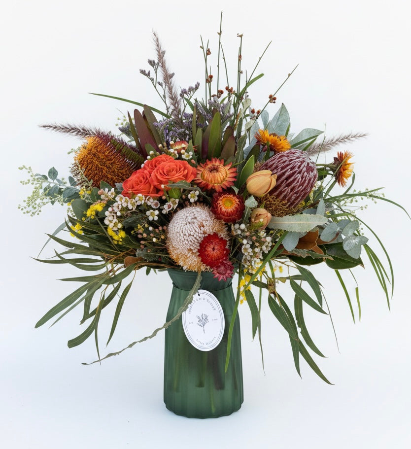Mixed posy in glass vase in
