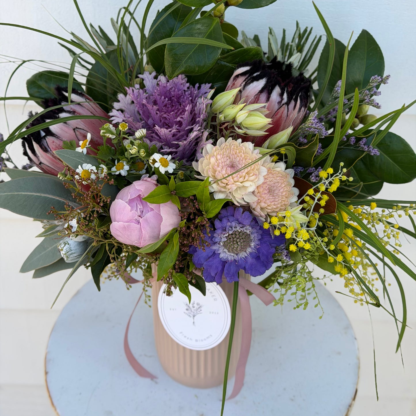 Mixed posy in glass vase in