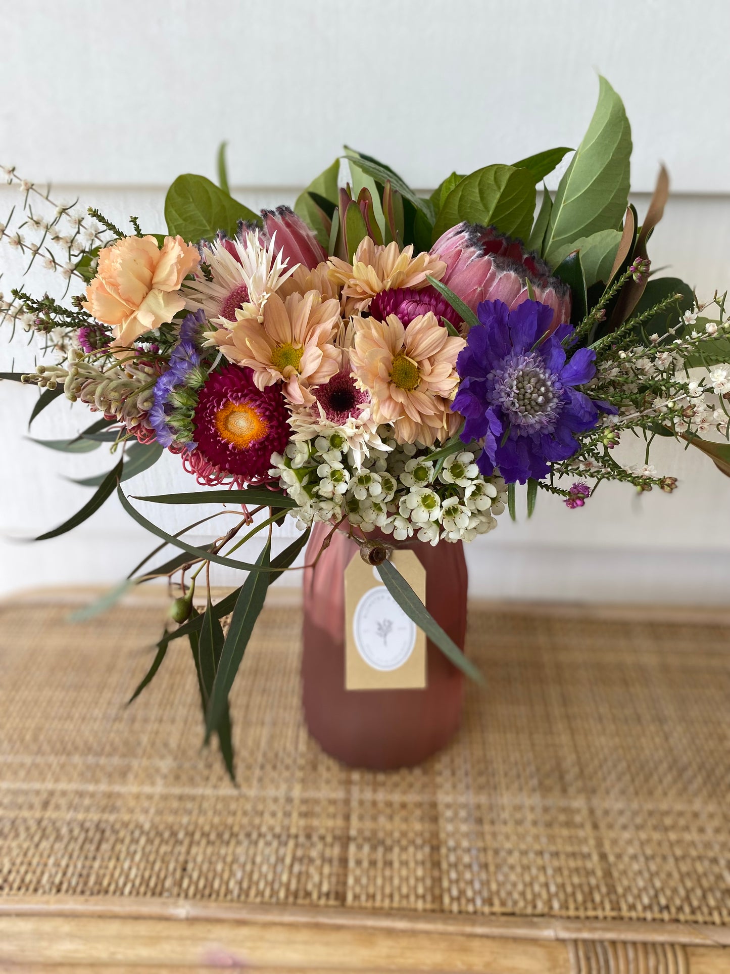 Mixed posy in glass vase in