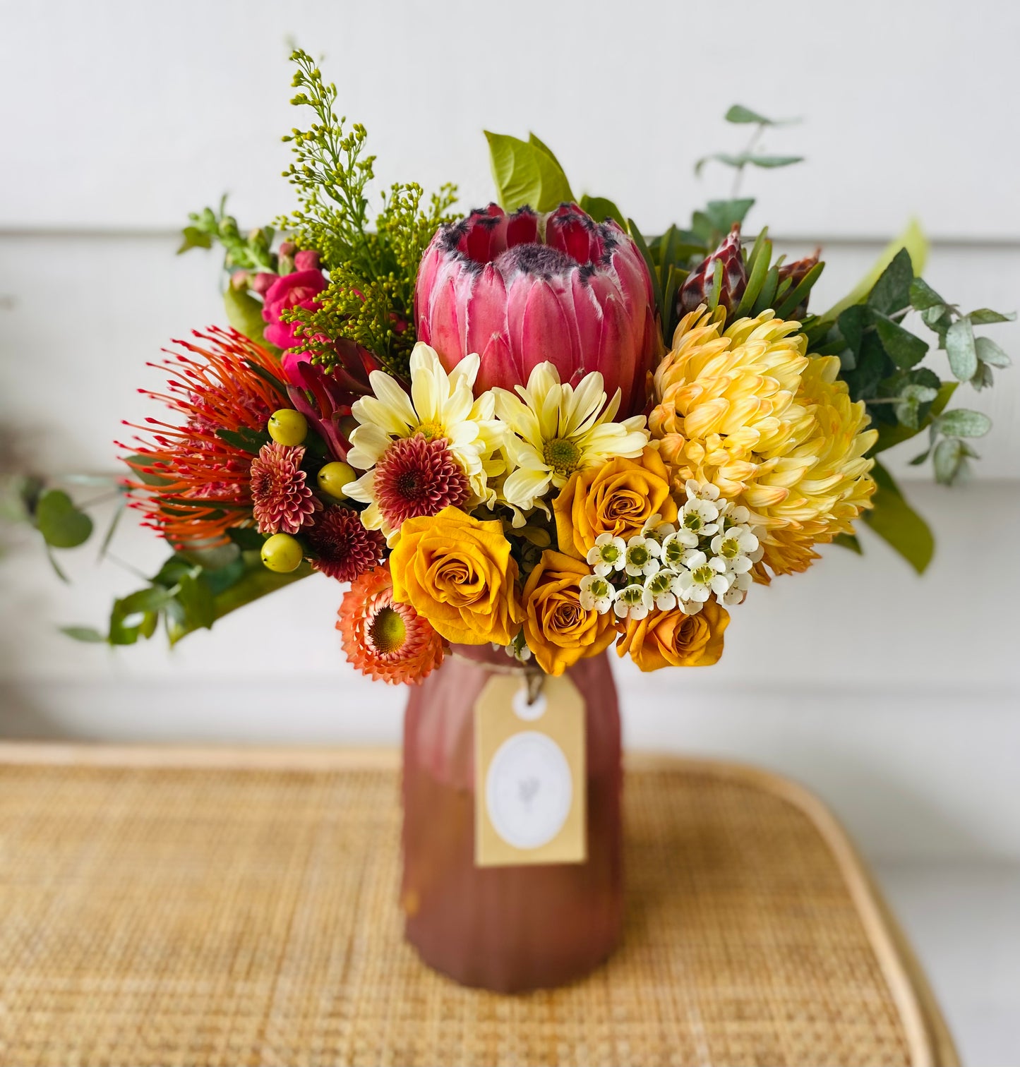 Mixed posy in glass vase in