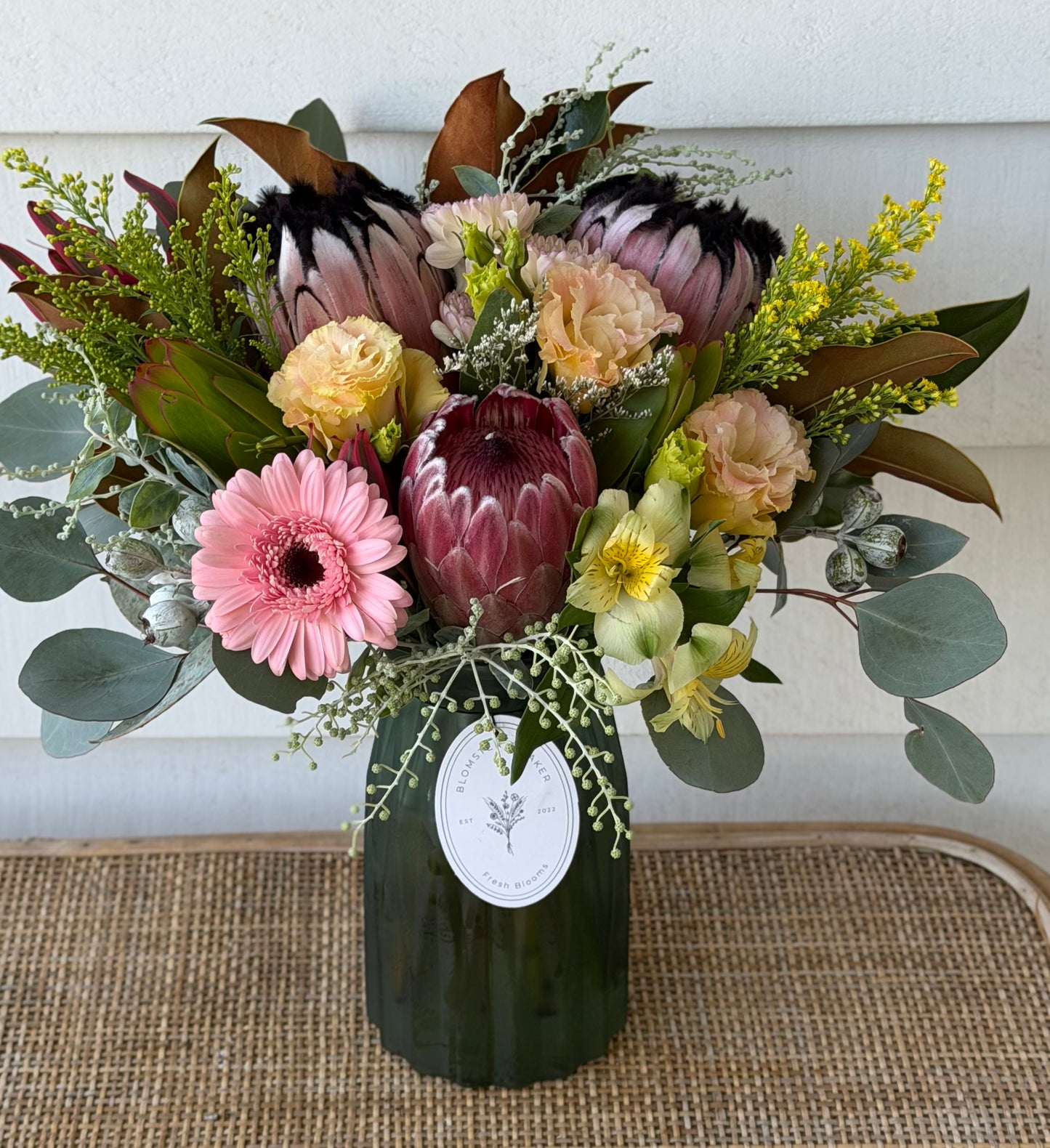 Mixed posy in glass vase in