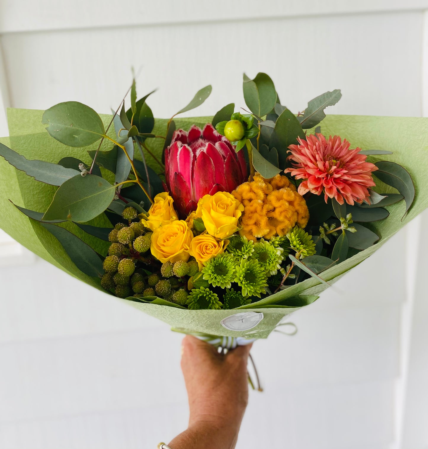 A mixed posy with a large Rober Gordon shopping bag